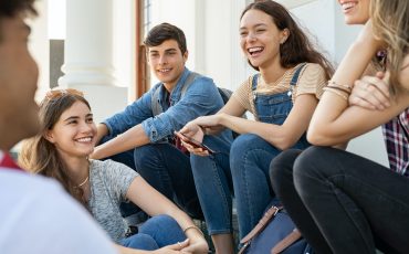 Teenager friends sitting together and laughing